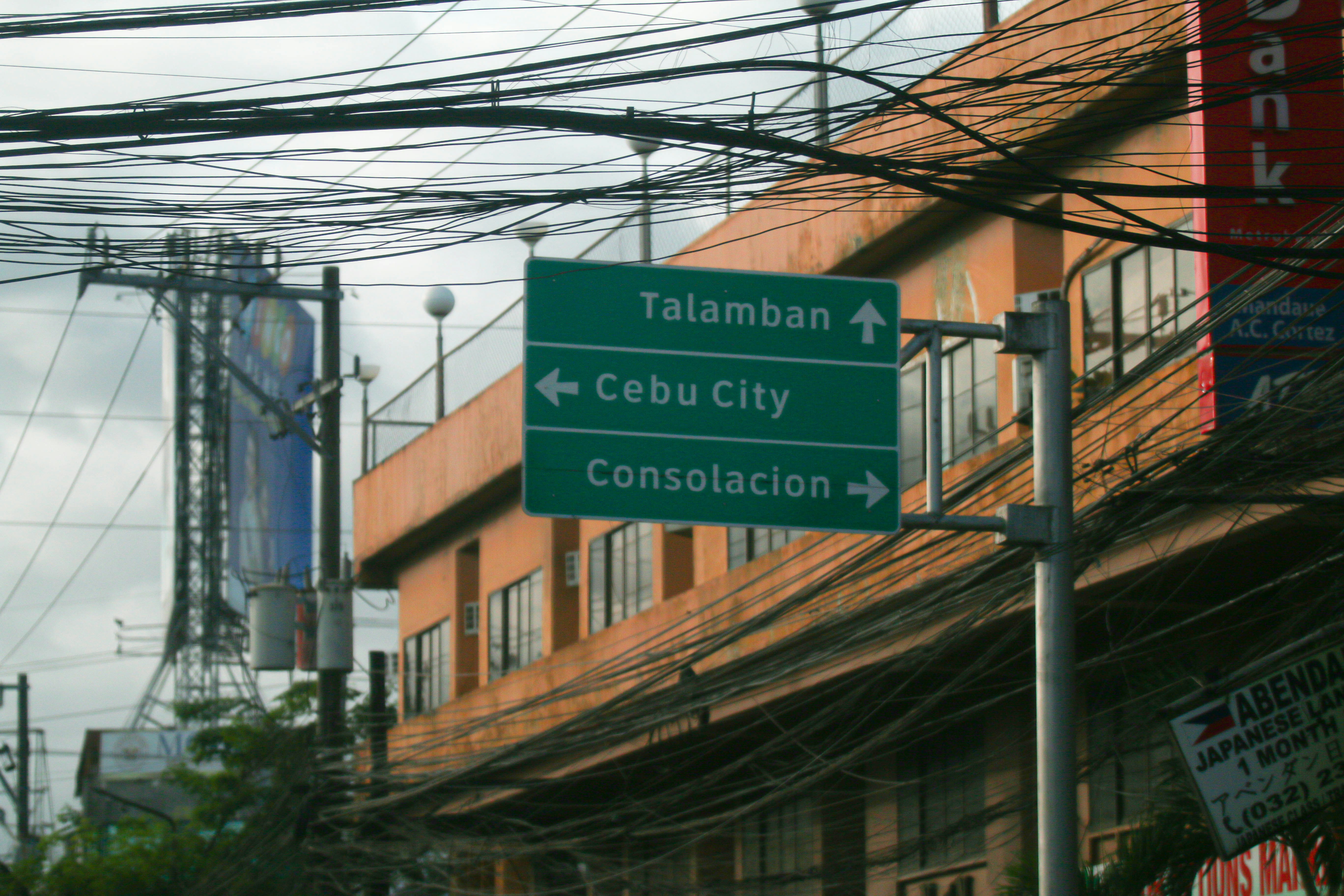 a green street sign sitting on the side of a road